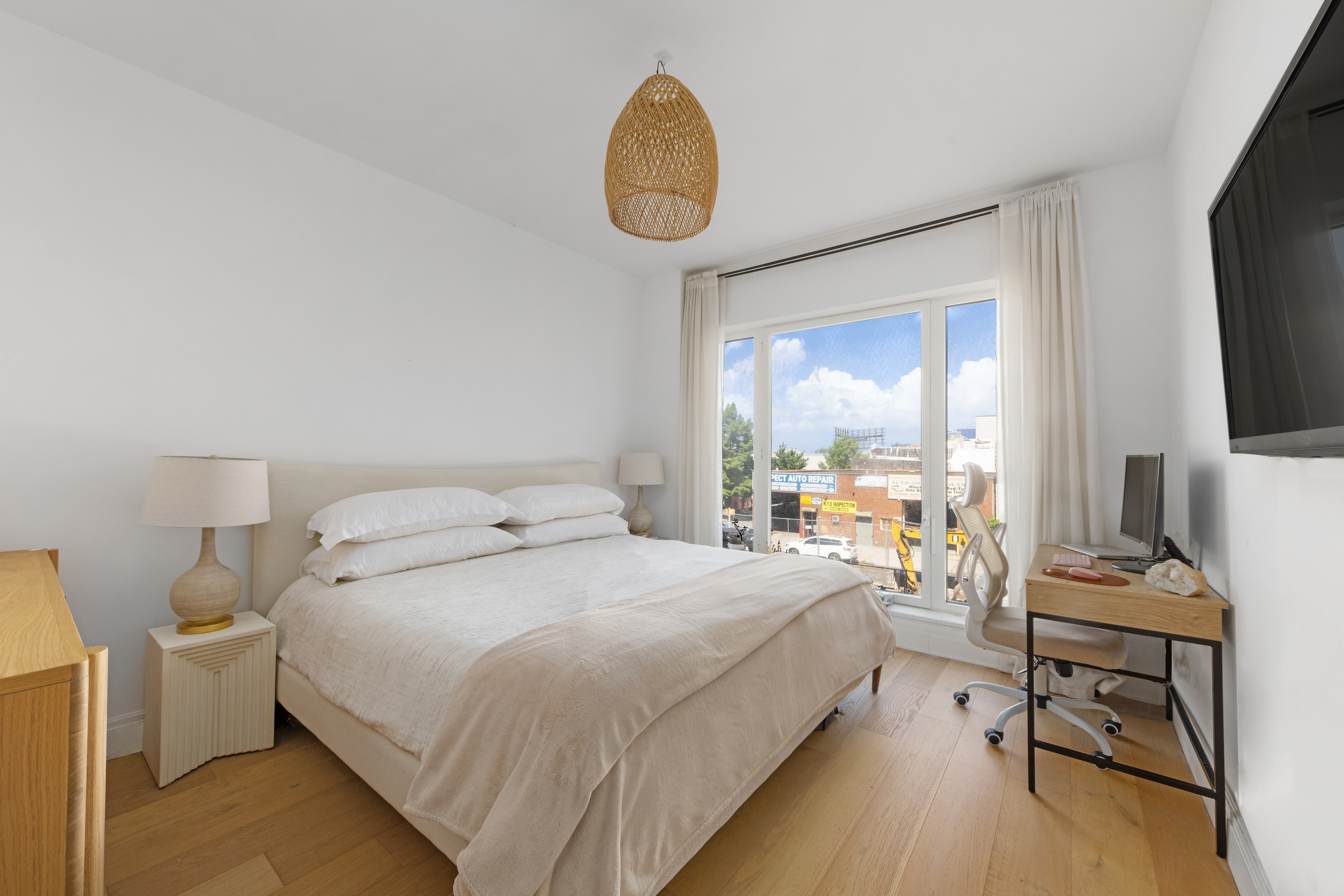 181 18th Street, Unit 204 Brooklyn, NY 11215 - Photo 3 of 15 a bedroom with a bed a mirror and a large window