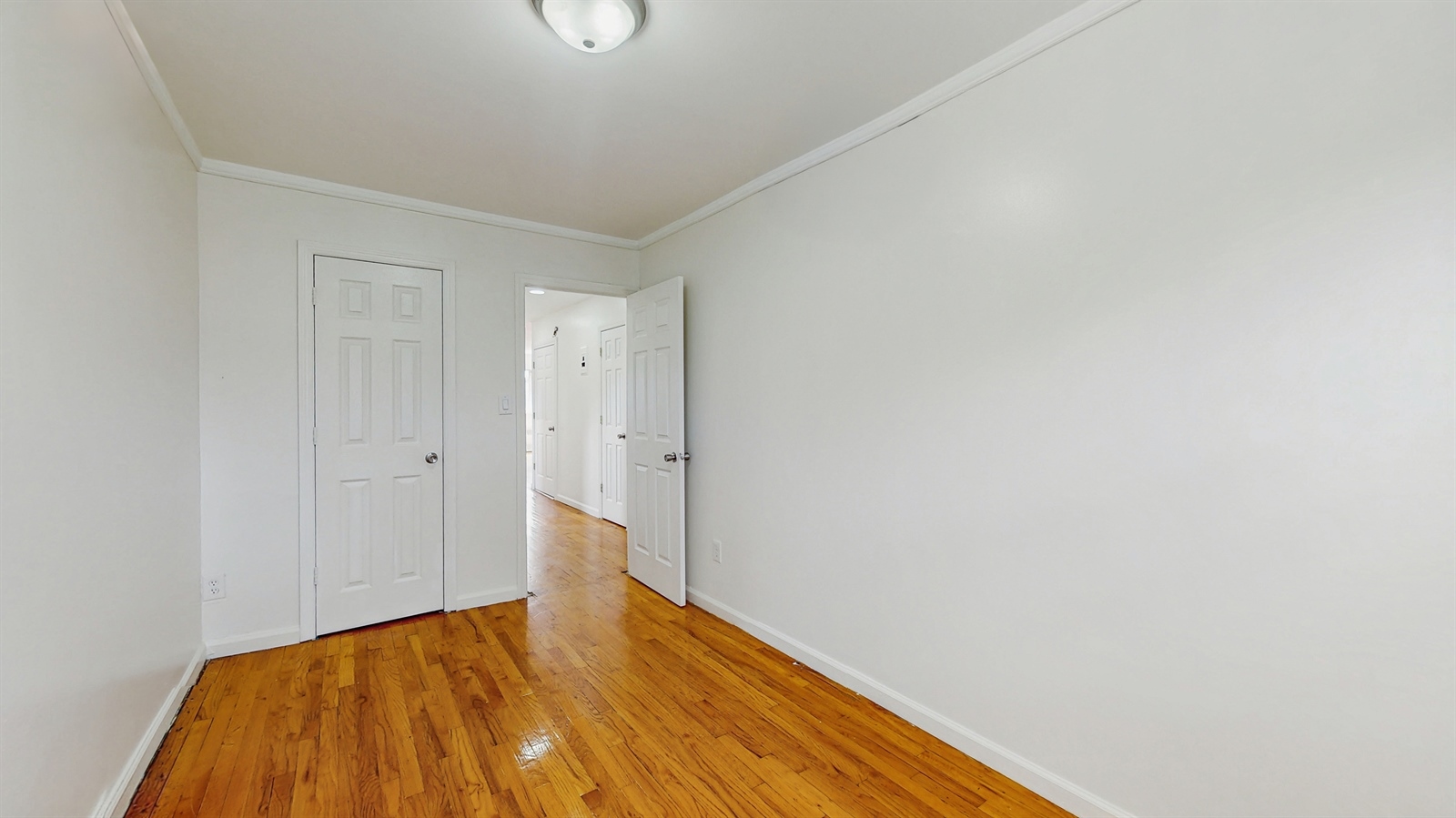 295 Conklin Avenue, Unit 3 Brooklyn, NY 11236 - Photo 12 of 15 a view of hallway with wooden floor