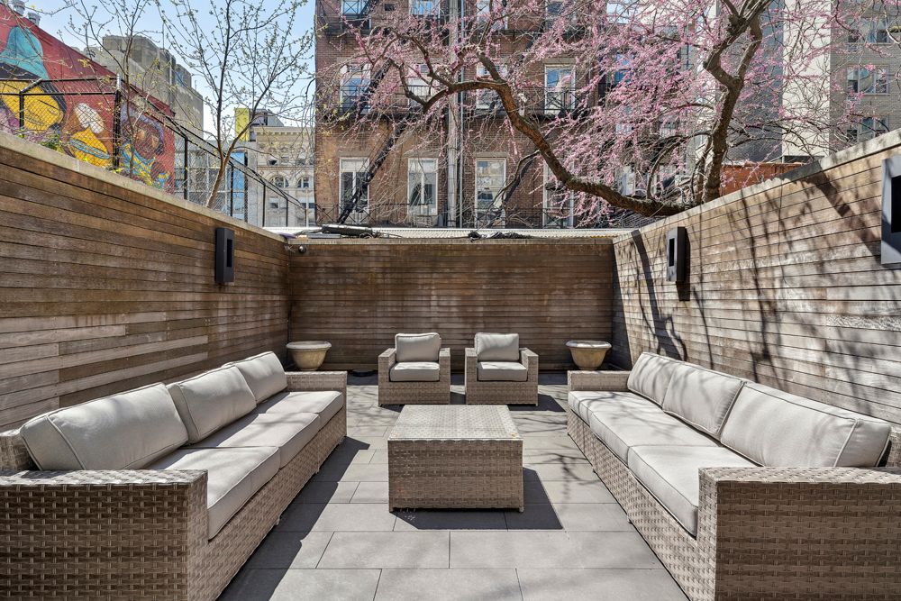 a view of patio with couches and a fire pit