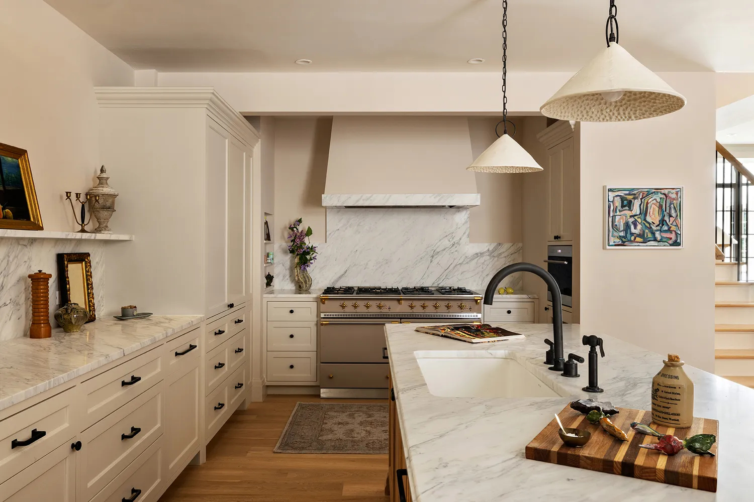 a kitchen with granite countertop a stove a sink and a chandelier