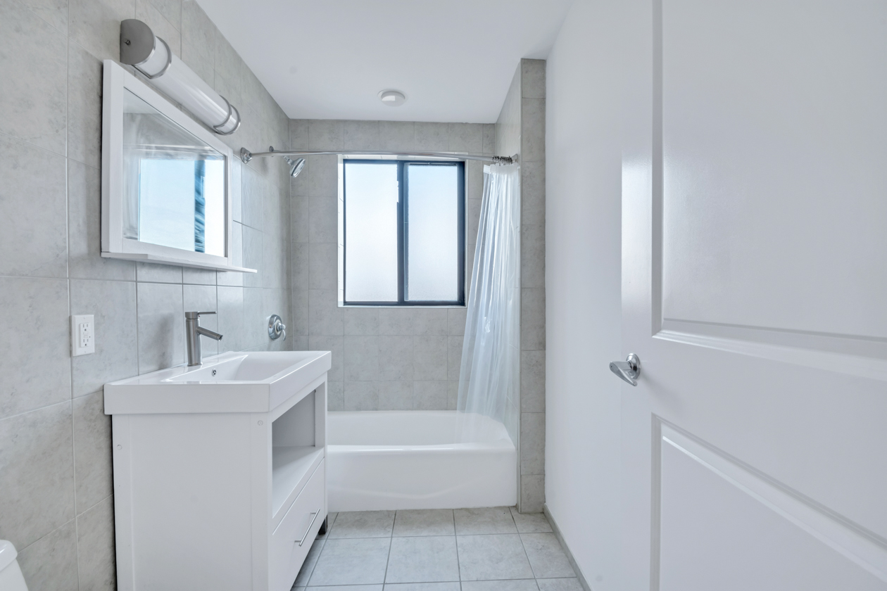 416 East 117th Street, Unit PH6 Manhattan, NY 10035 - Photo 13 of 20 a white bath tub sitting next to a white sink