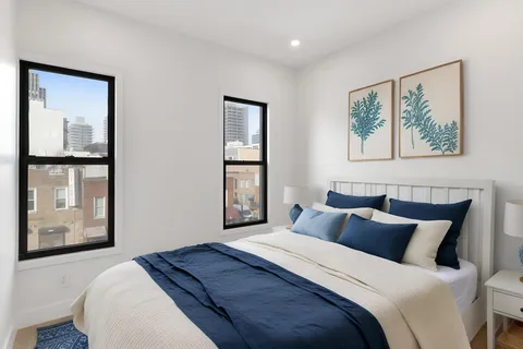 a bedroom with a large bed and a window