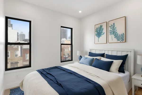 a bedroom with a large bed and a window