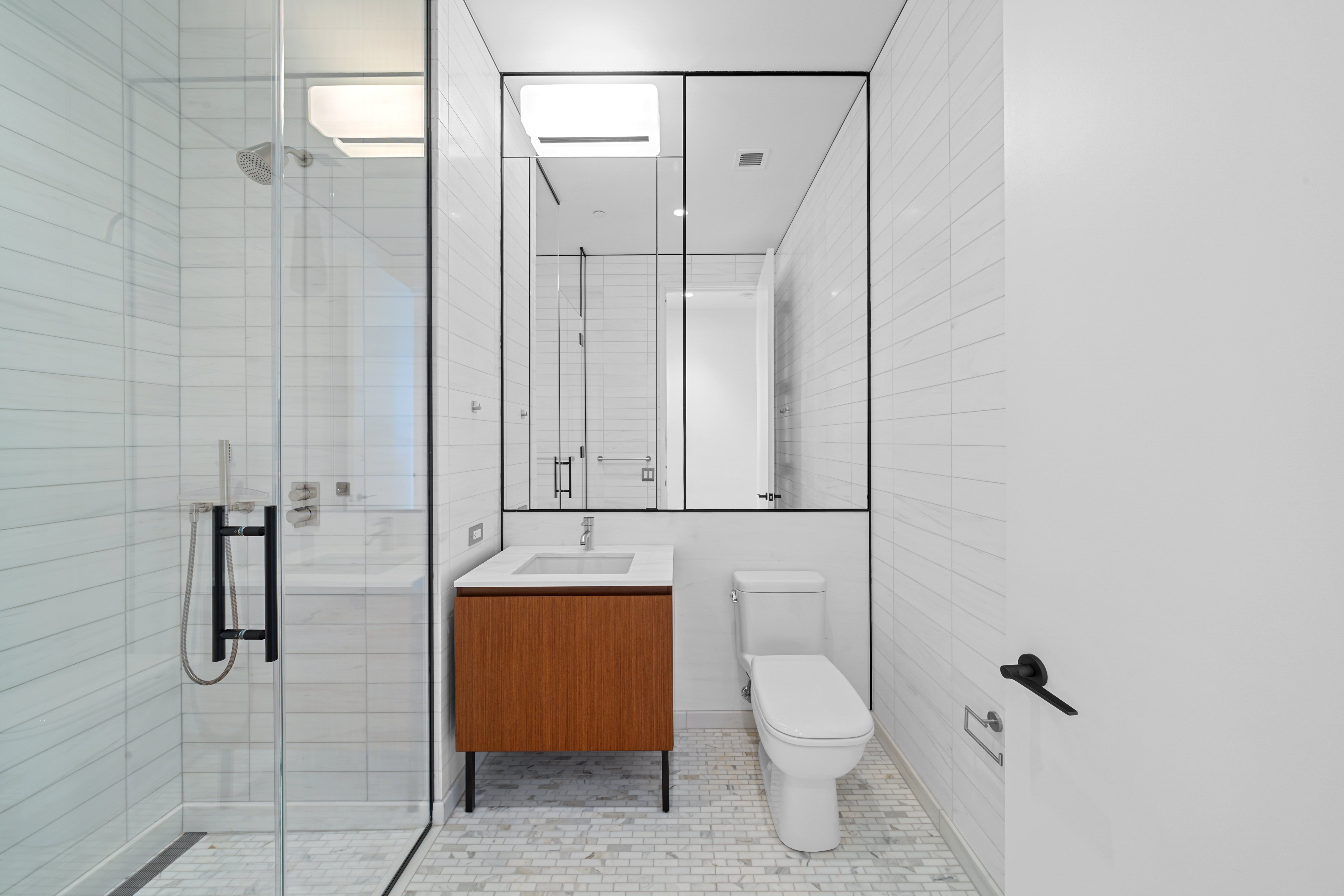 15 East 30th Street, Unit 19B Manhattan, NY 10016 - Photo 25 of 40 a bathroom with a granite countertop sink toilet and shower