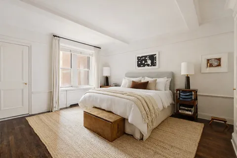 a spacious bedroom with a bed and a night stand