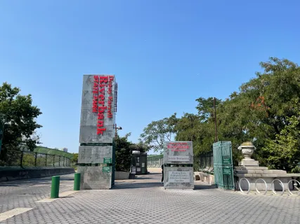 a street sign on a sidewalk next to a road