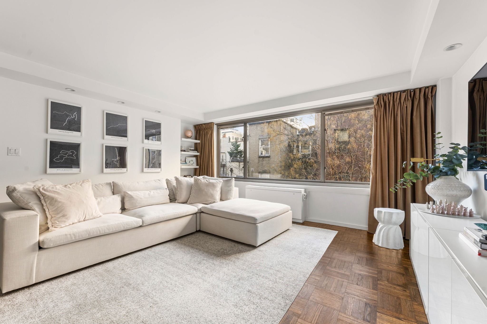 315 West 70th Street, Unit 5F Manhattan, NY 10023 - Photo 2 of 9 a living room with furniture and a large window