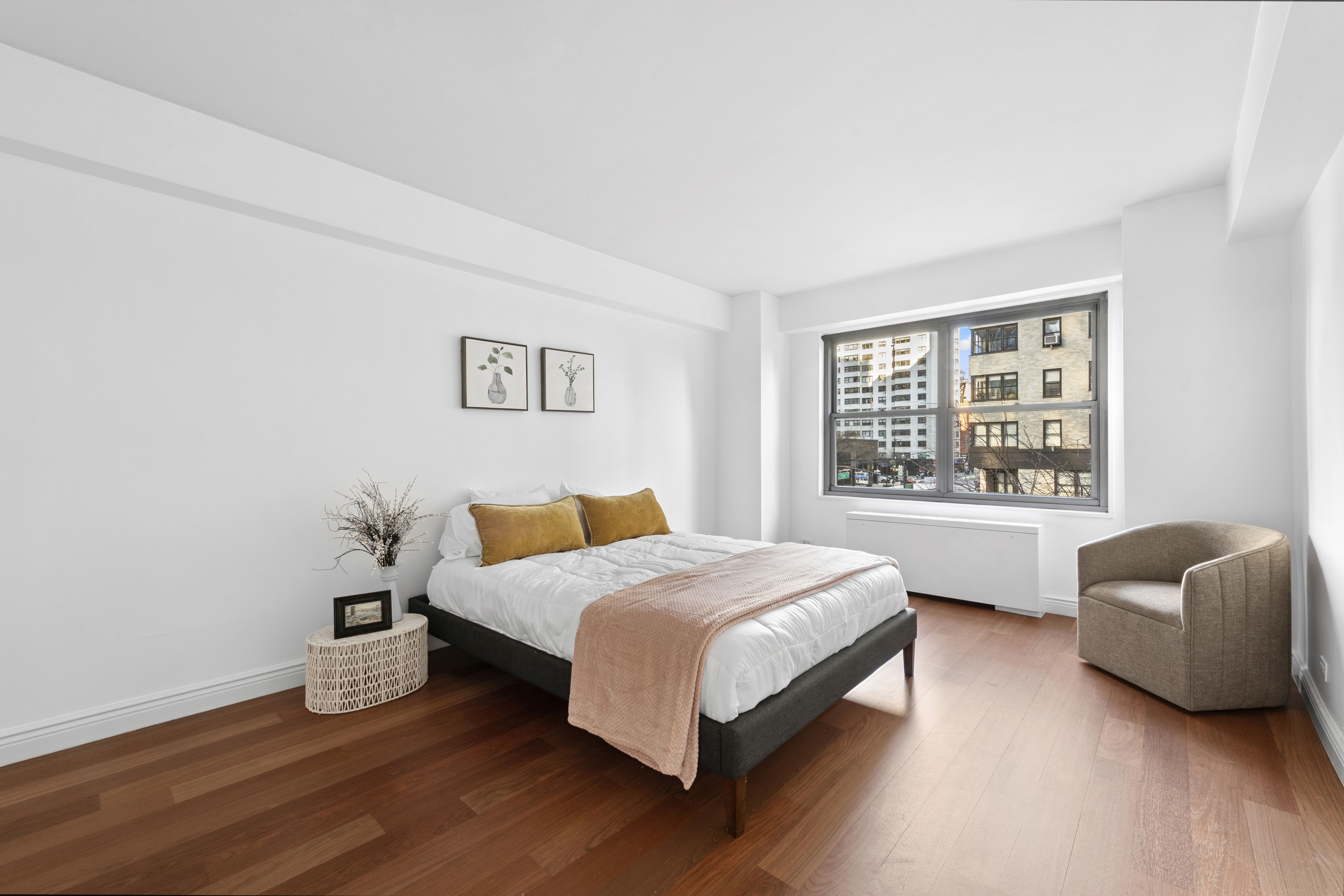 400 East 56th Street, Unit 3D Manhattan, NY 10022 - Photo 5 of 24 a bedroom with a bed and a couch