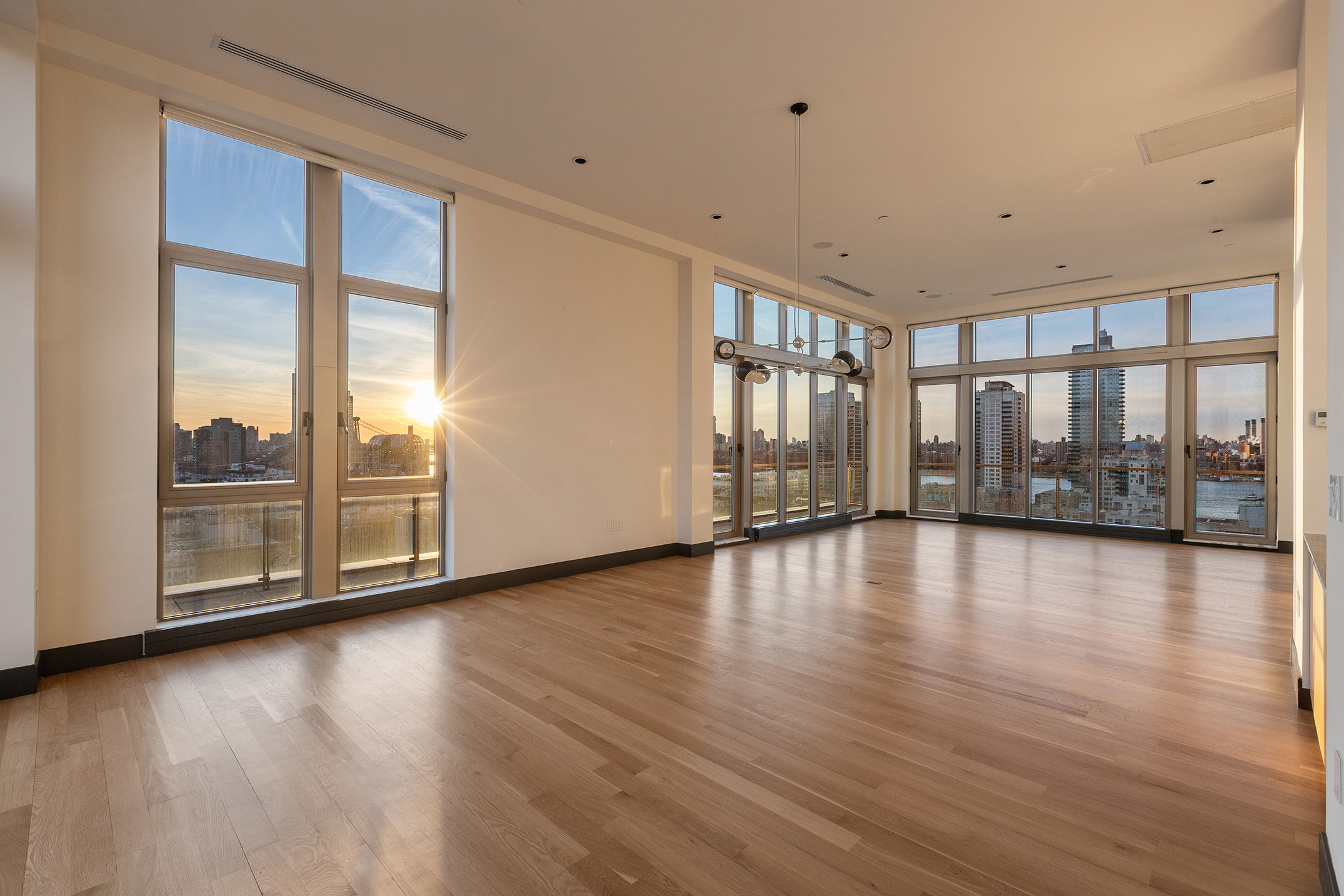 144 North 8th Street, Unit PH2 Brooklyn, NY 11249 - Photo 3 of 20 a view of an empty room with wooden floor and a window