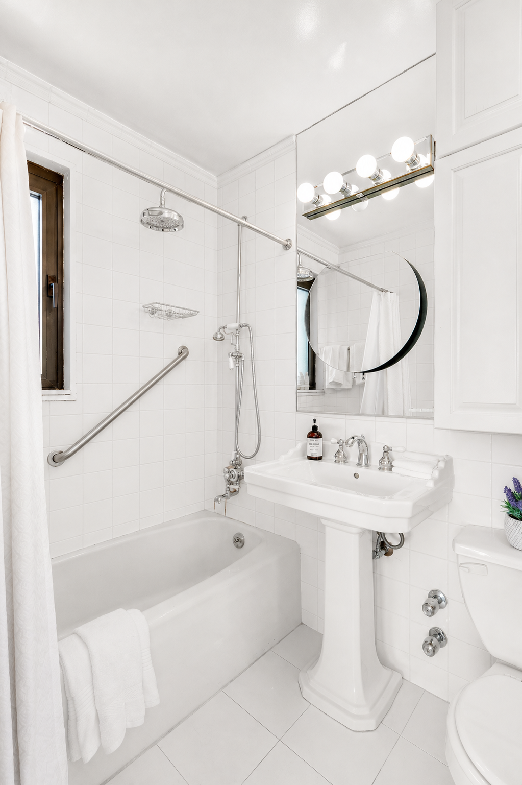 10 West 66th Street, Unit 29E Manhattan, NY 10023 - Photo 13 of 39 a bathroom with a sink vanity mirror bathtub and toilet