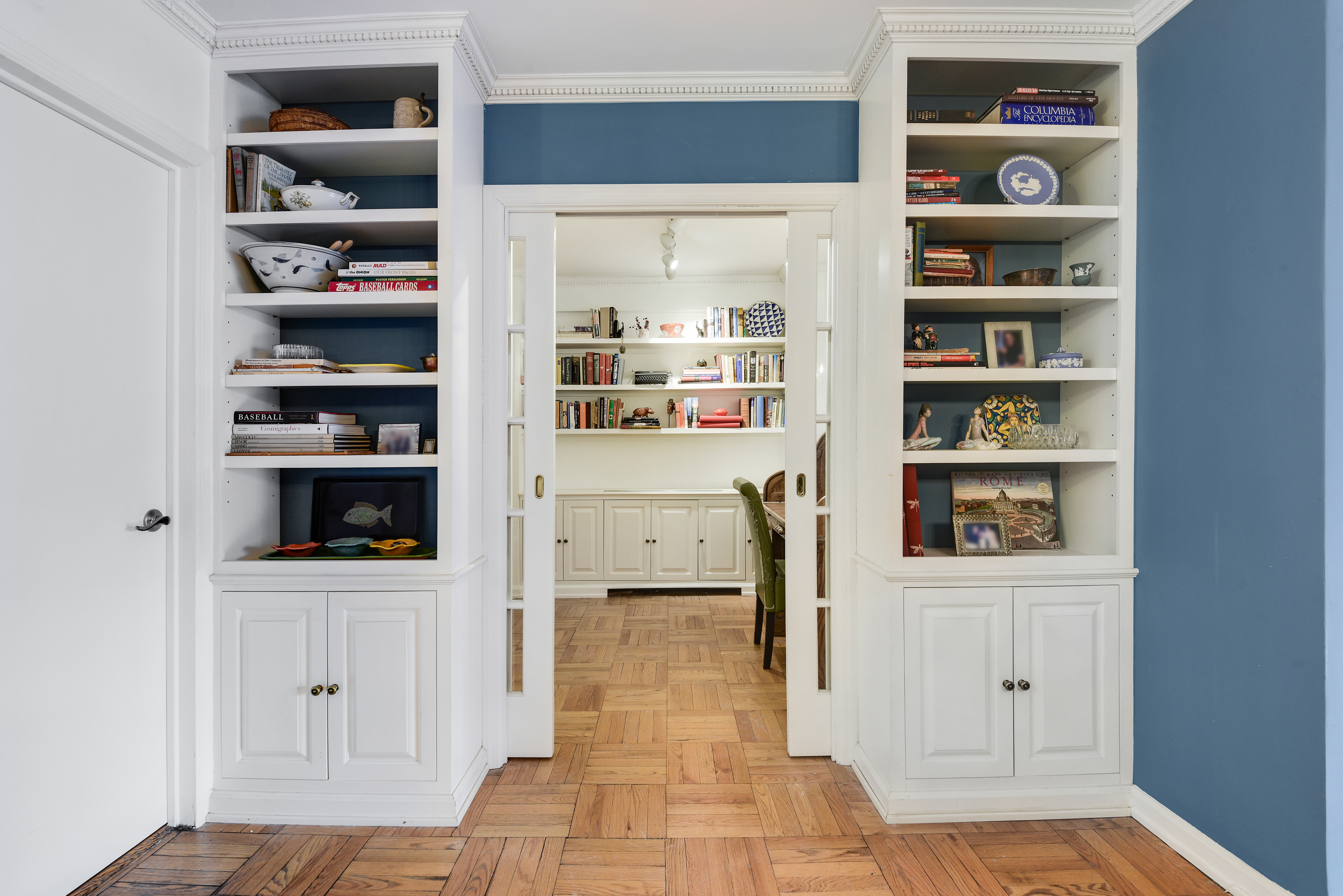 150 East 61st Street, Unit 5C Manhattan, NY 10065 - Photo 2 of 18 a hallway with cabinets and wooden floor