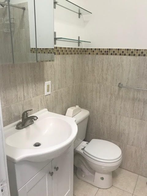 54 West 89th Street, Unit 3R Manhattan, NY 10024 - Photo 4 of 6 a bathroom with a sink a toilet and a mirror