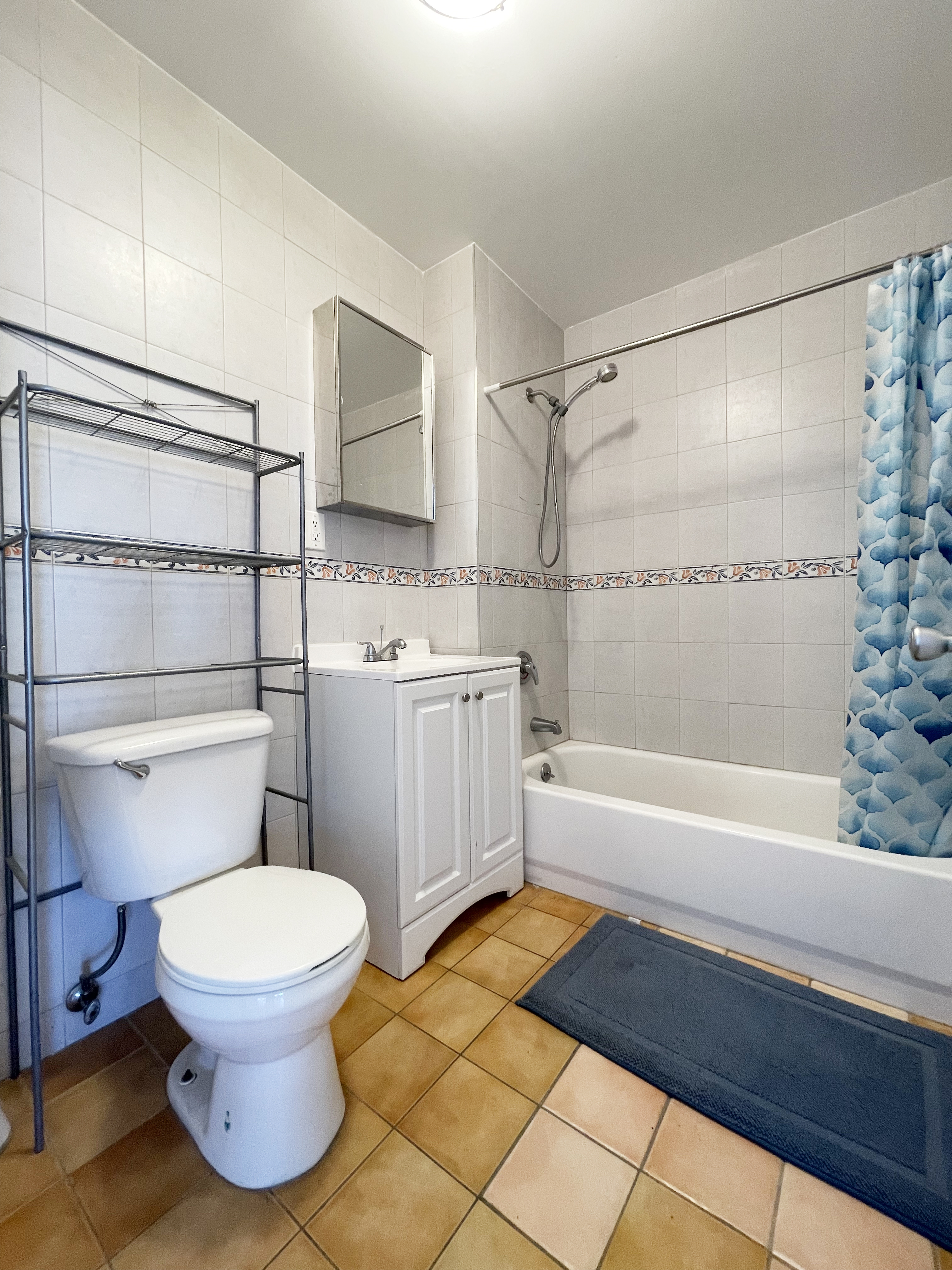 71-33 162nd Street, Unit 5A Queens, NY 11365 - Photo 4 of 5 a bathroom with a sink toilet and shower