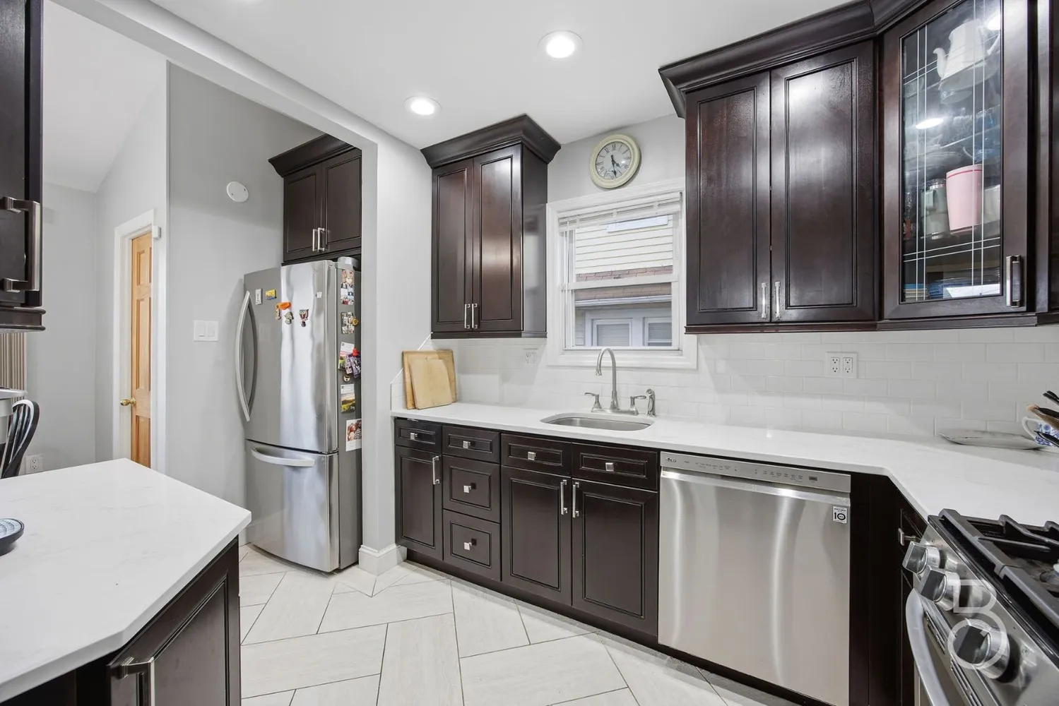 a kitchen with stainless steel appliances granite countertop a sink a stove a refrigerator and island