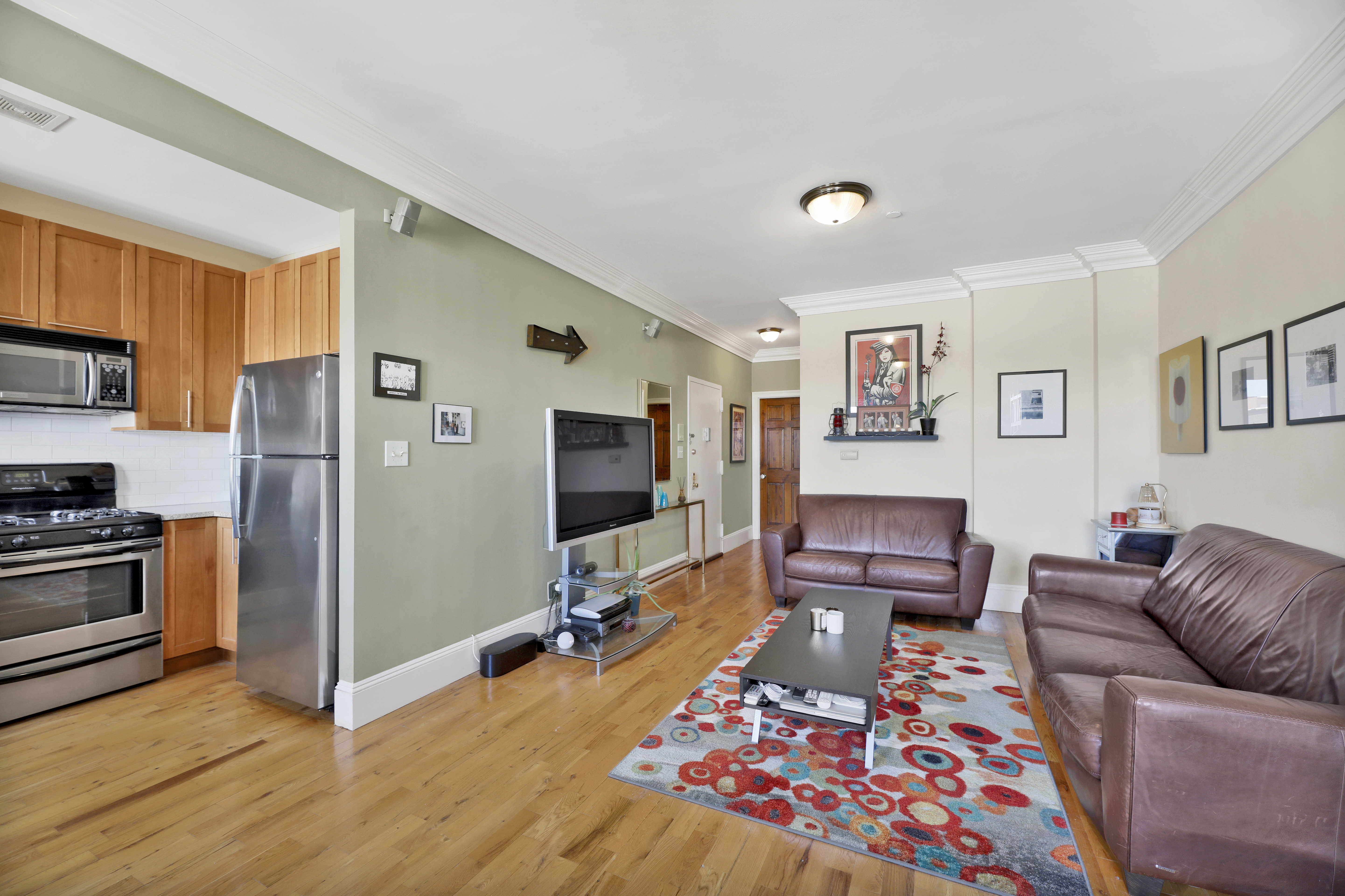36 Russell Street, Unit 22 Brooklyn, NY 11222 - Photo 17 of 27 a living room with furniture and a flat screen tv