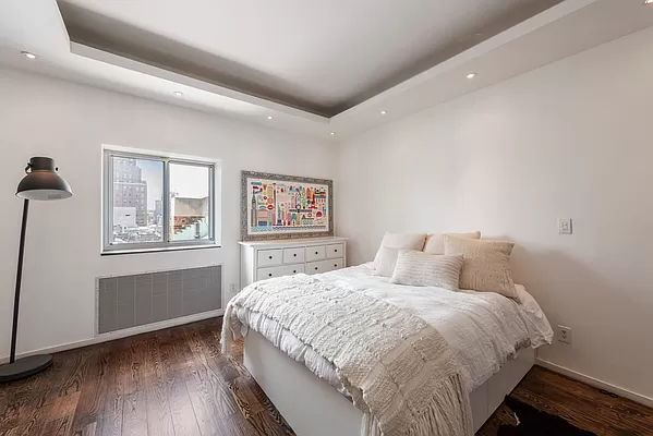 210 West 16th Street, Unit PH Manhattan, NY 10011 - Photo 7 of 16 a bedroom with a large bed and a window