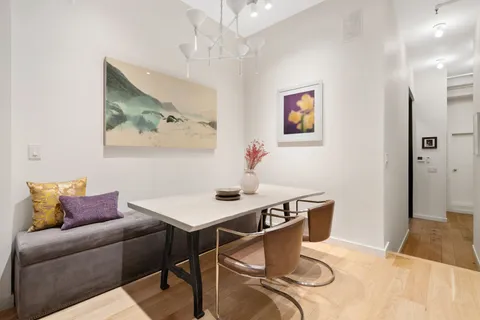 a living room with furniture a couch and wooden floor