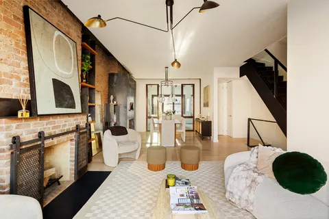 a living room with fireplace furniture and a flat screen tv