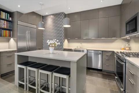 a kitchen with a stove a sink and a refrigerator