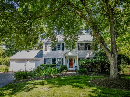 a front view of a house with yard and green space
