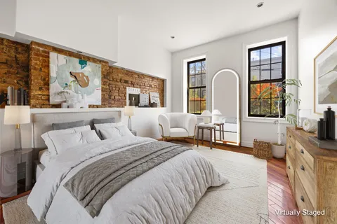 a bedroom with a large bed and a flat screen tv