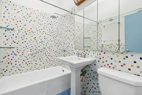 a bathroom with a sink a toilet and a shower curtain