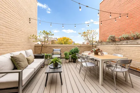 a view of a balcony with chairs and a table