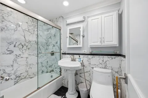 a bathroom with a sink toilet and shower