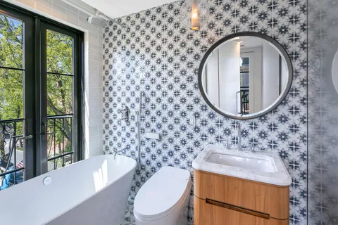 a bathroom with a sink a toilet and a mirror