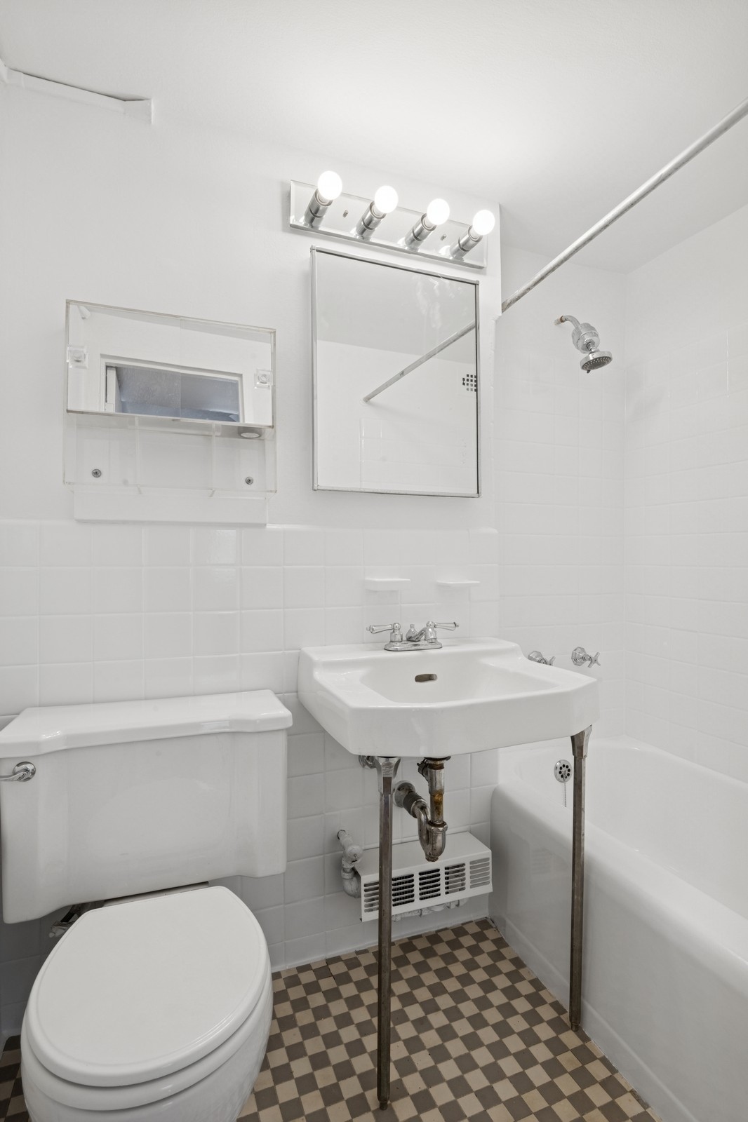 305 East 72nd Street, Unit 10G Manhattan, NY 10021 - Photo 5 of 6 a bathroom with a sink a toilet and vanity