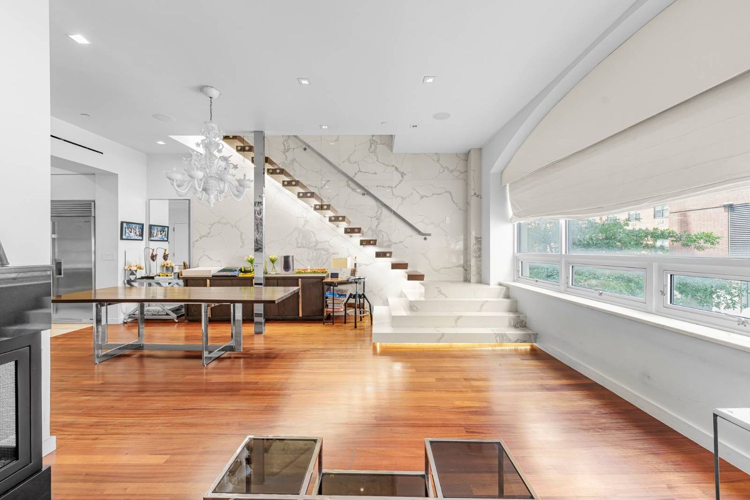a living room with lots of furniture and a large window
