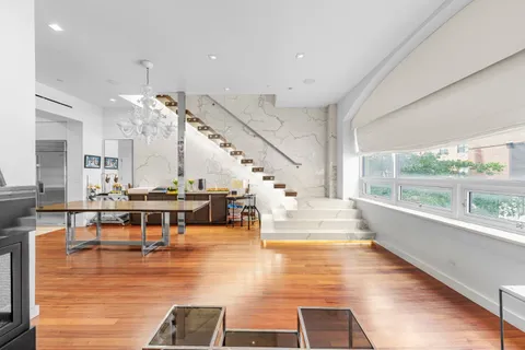 a living room with lots of furniture and a large window