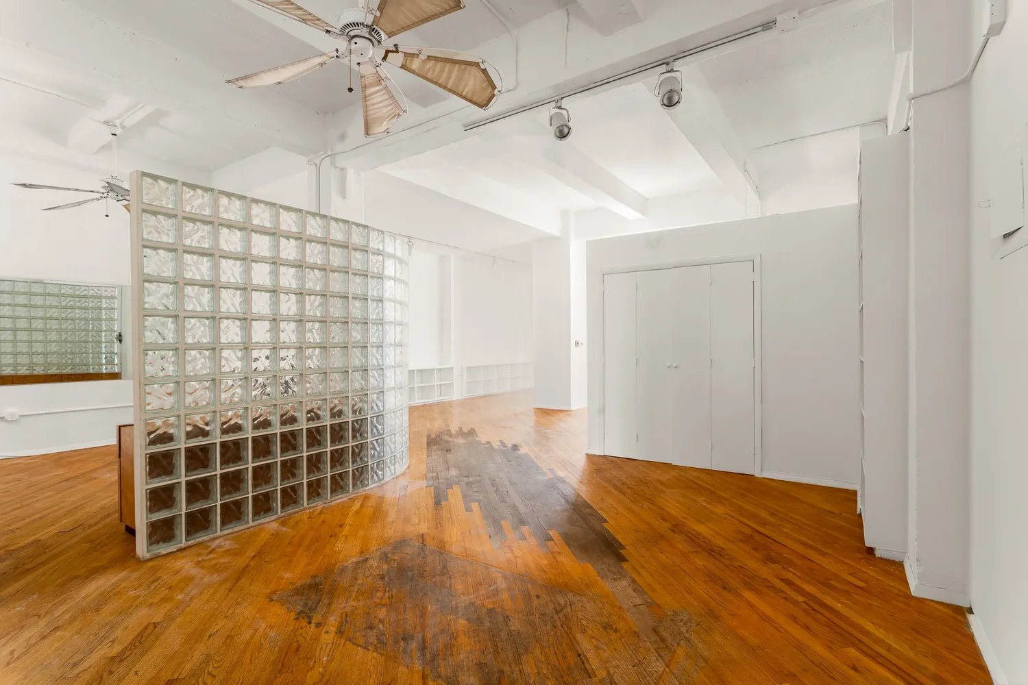 a view of empty room with wooden floor