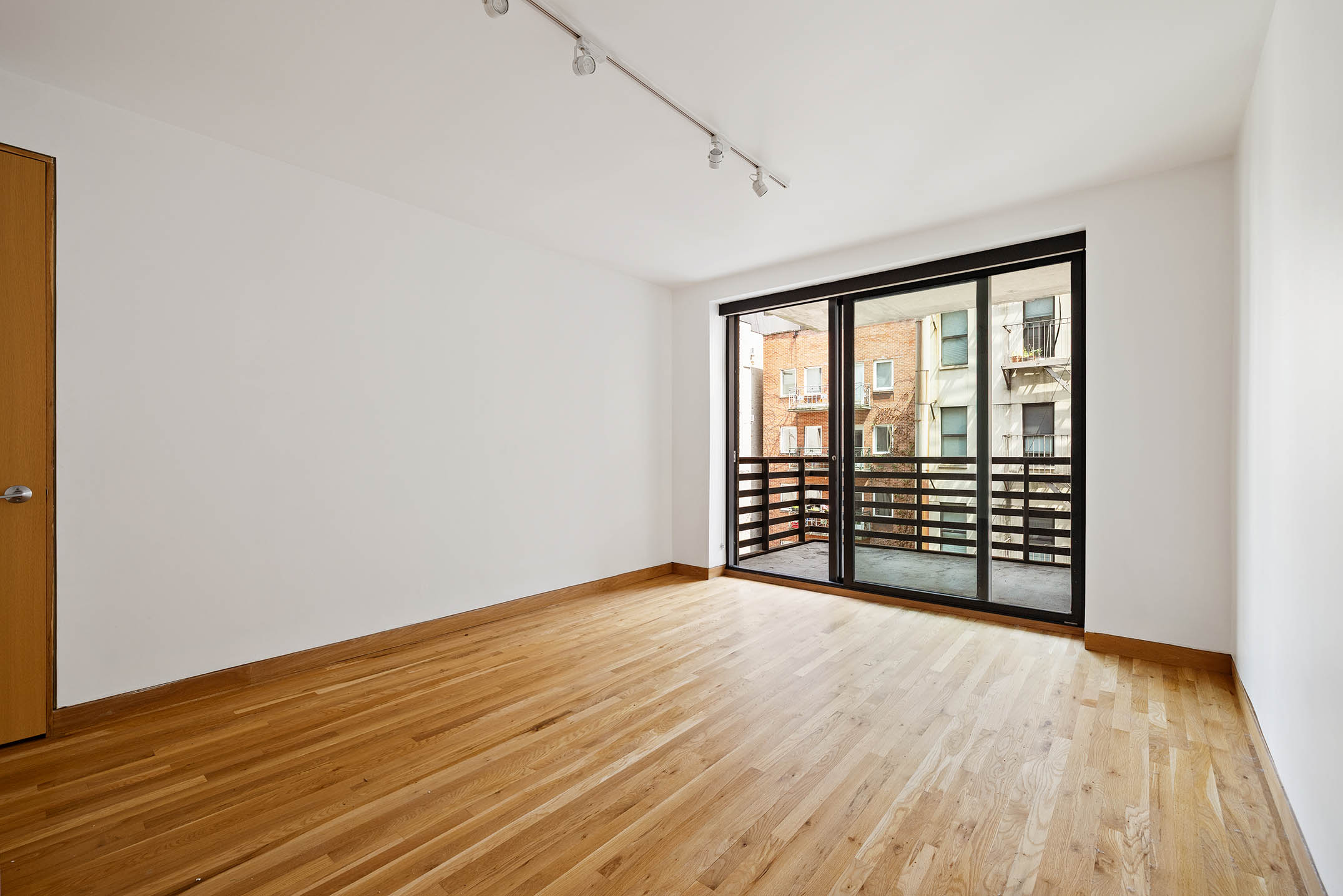 75 Sullivan Street, Unit 5S Manhattan, NY 10012 - Photo 9 of 12 wooden floor in an empty room with a window