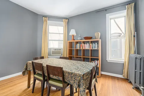 a dining room with furniture and window