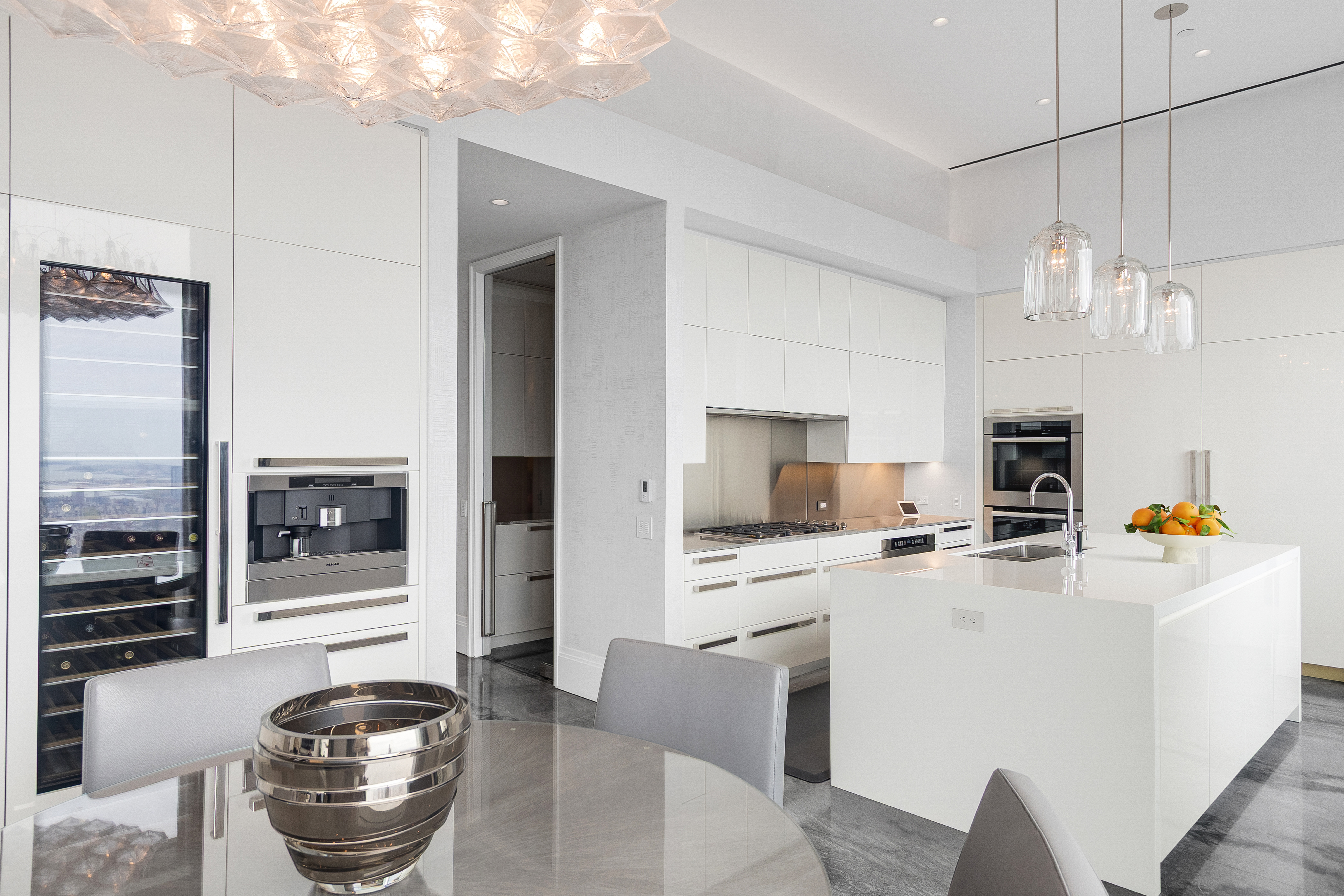 432 Park Avenue, Unit PH88 Manhattan, NY 10022 - Photo 13 of 17 a kitchen with stainless steel appliances granite countertop a stove and a sink