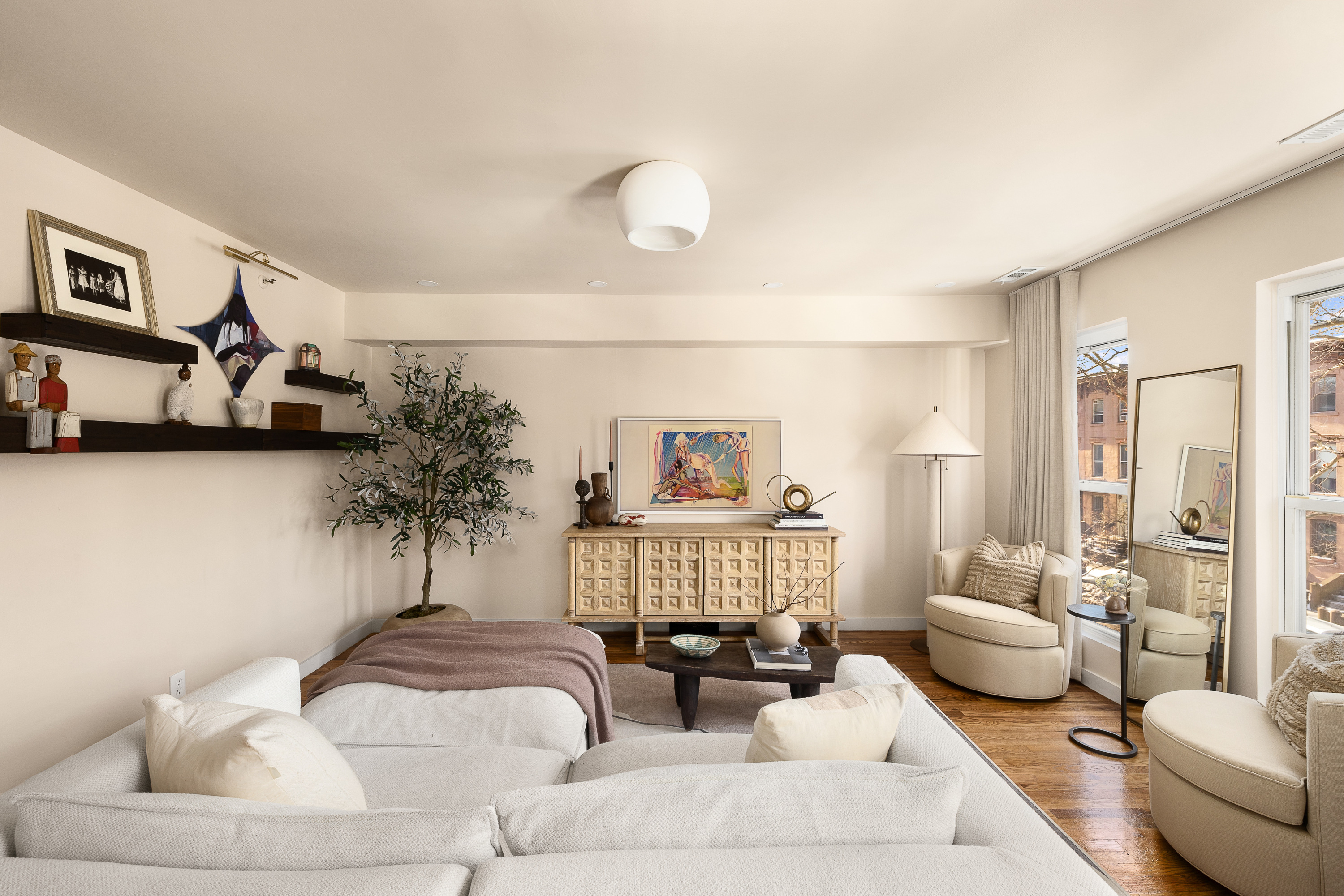 325 Grand Avenue, Unit A Brooklyn, NY 11238 - Photo 2 of 10 a living room with furniture and a painting on the wall