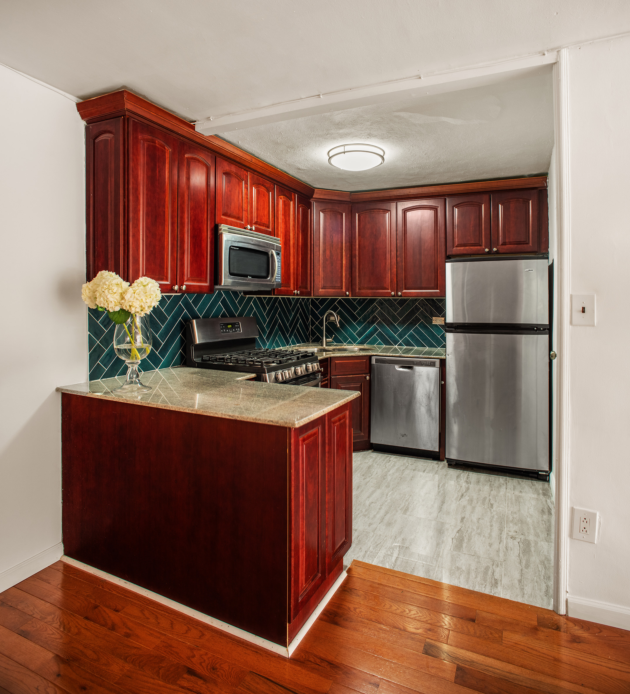 85 Livingston Street, Unit 3H Brooklyn, NY 11201 - Photo 7 of 9 a kitchen with stainless steel appliances granite countertop a refrigerator a stove and a wooden floors