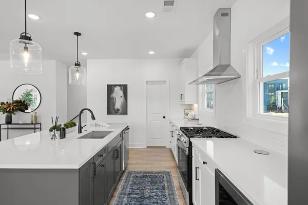 a kitchen with a sink stove and cabinets