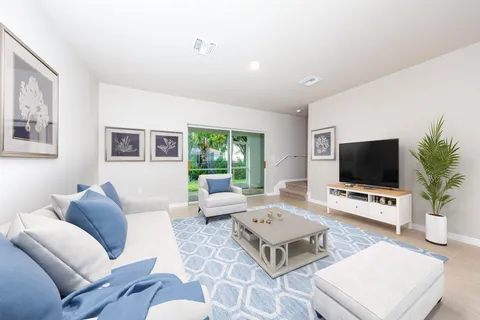 a living room with furniture a rug and a flat screen tv