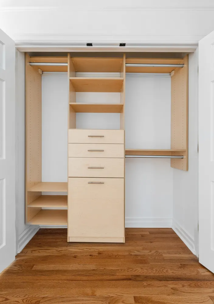 a view of walk in closet with empty racks