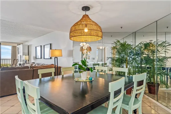 a living room with dining table furniture and a chandelier