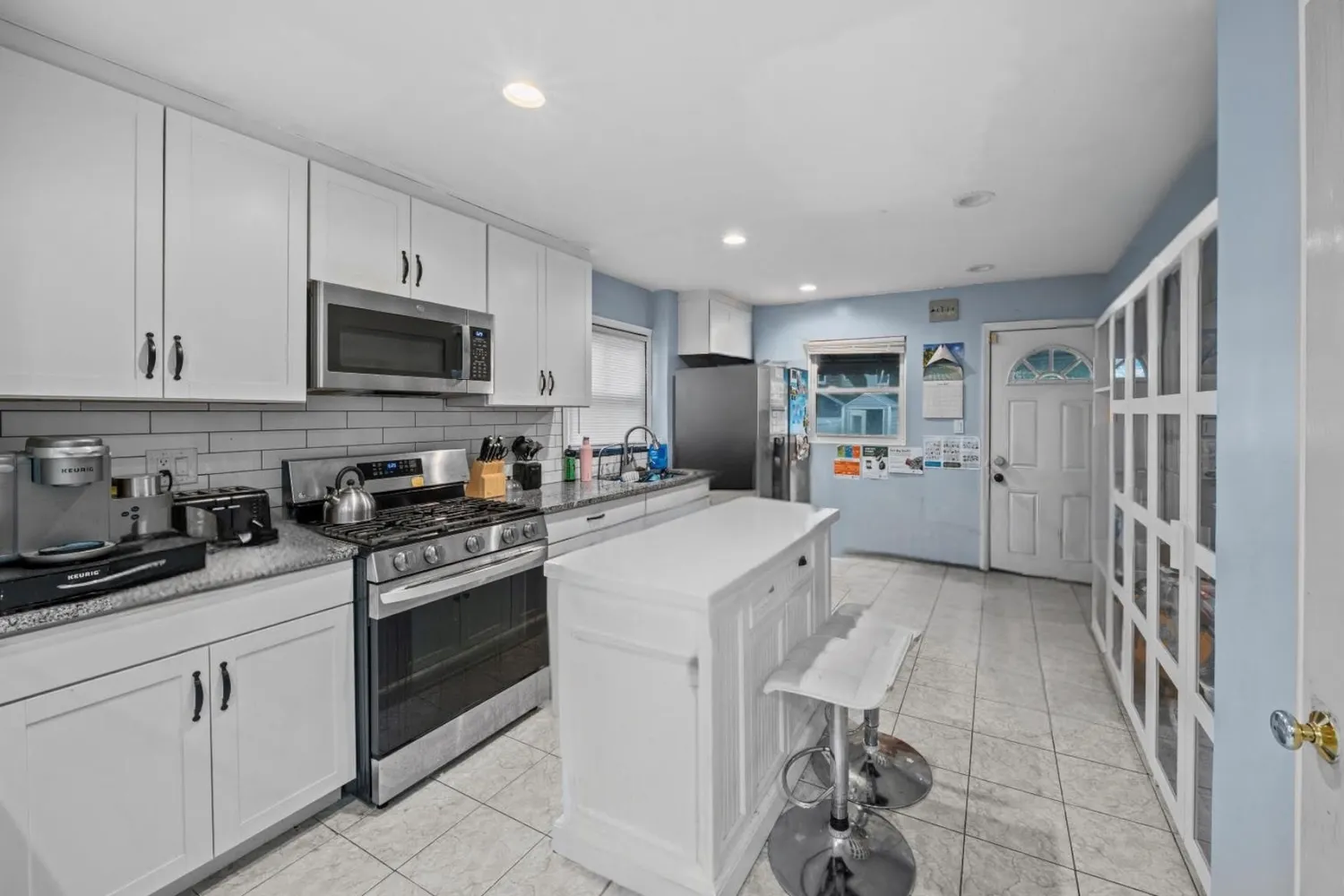 a kitchen with cabinets appliances a sink and a counter top space