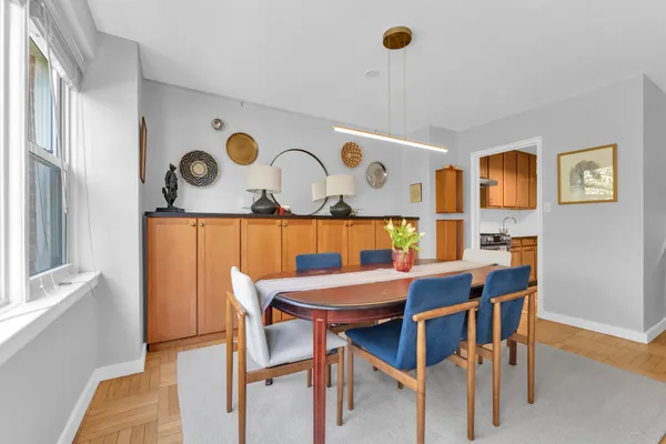 a view of a dining room with furniture and wooden floor