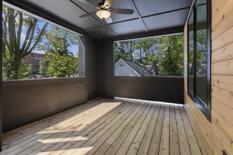 a view of an empty room with cabinet and a window