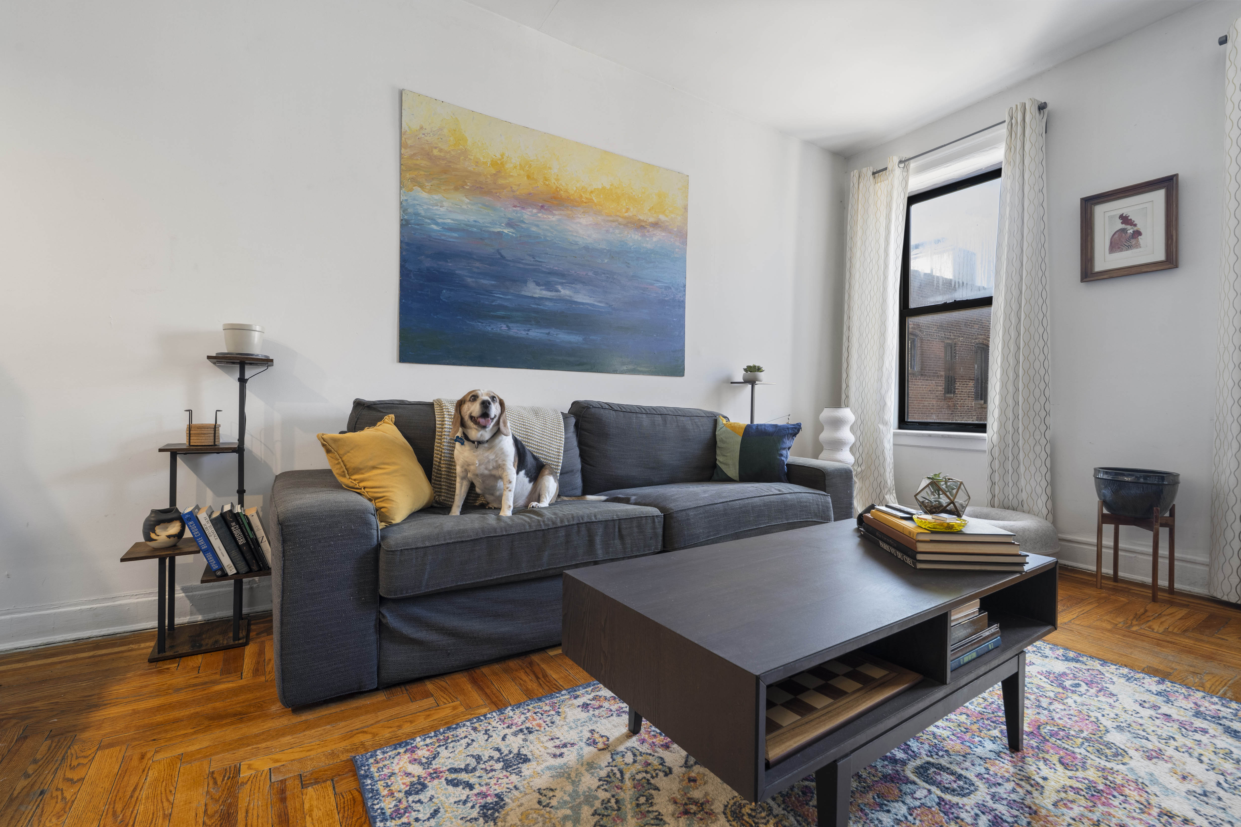 a living room with furniture and a wooden floor