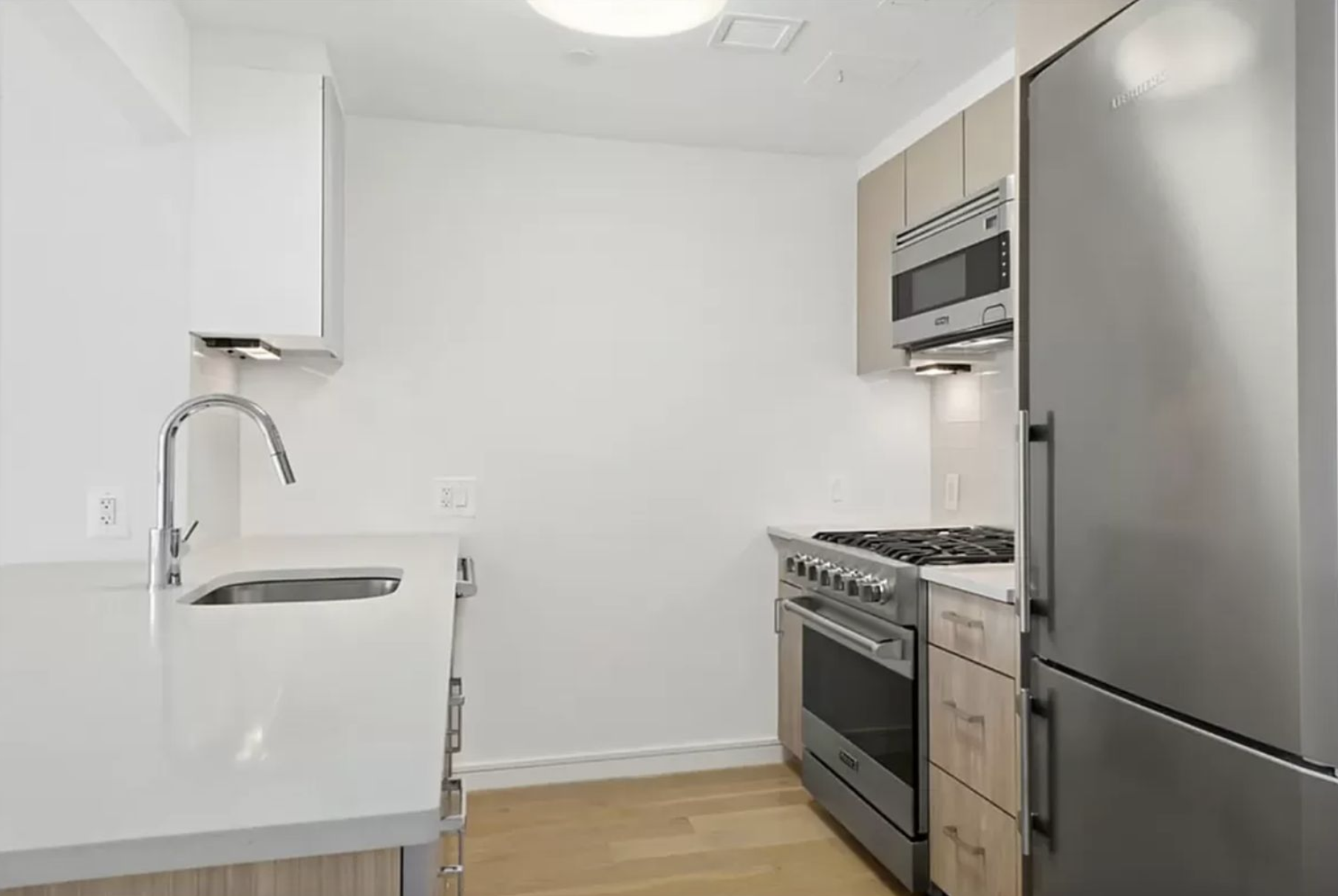171 West 131st Street, Unit PH4 Manhattan, NY 10027 - Photo 2 of 10 a kitchen with a stove and a microwave