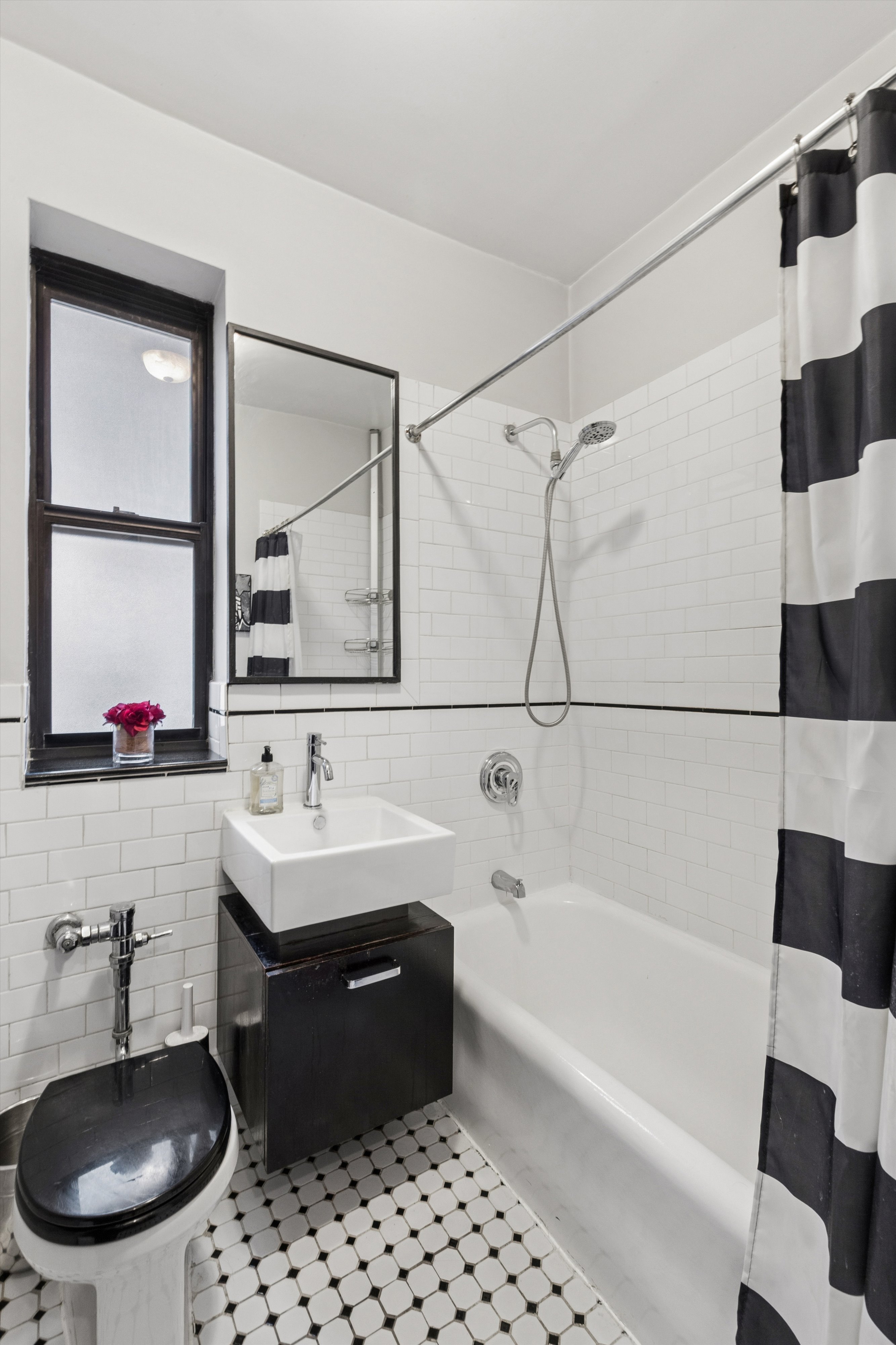 24 Bennett Avenue, Unit 62A Manhattan, NY 10033 - Photo 9 of 14 a bathroom with a sink a bathtub and a mirror