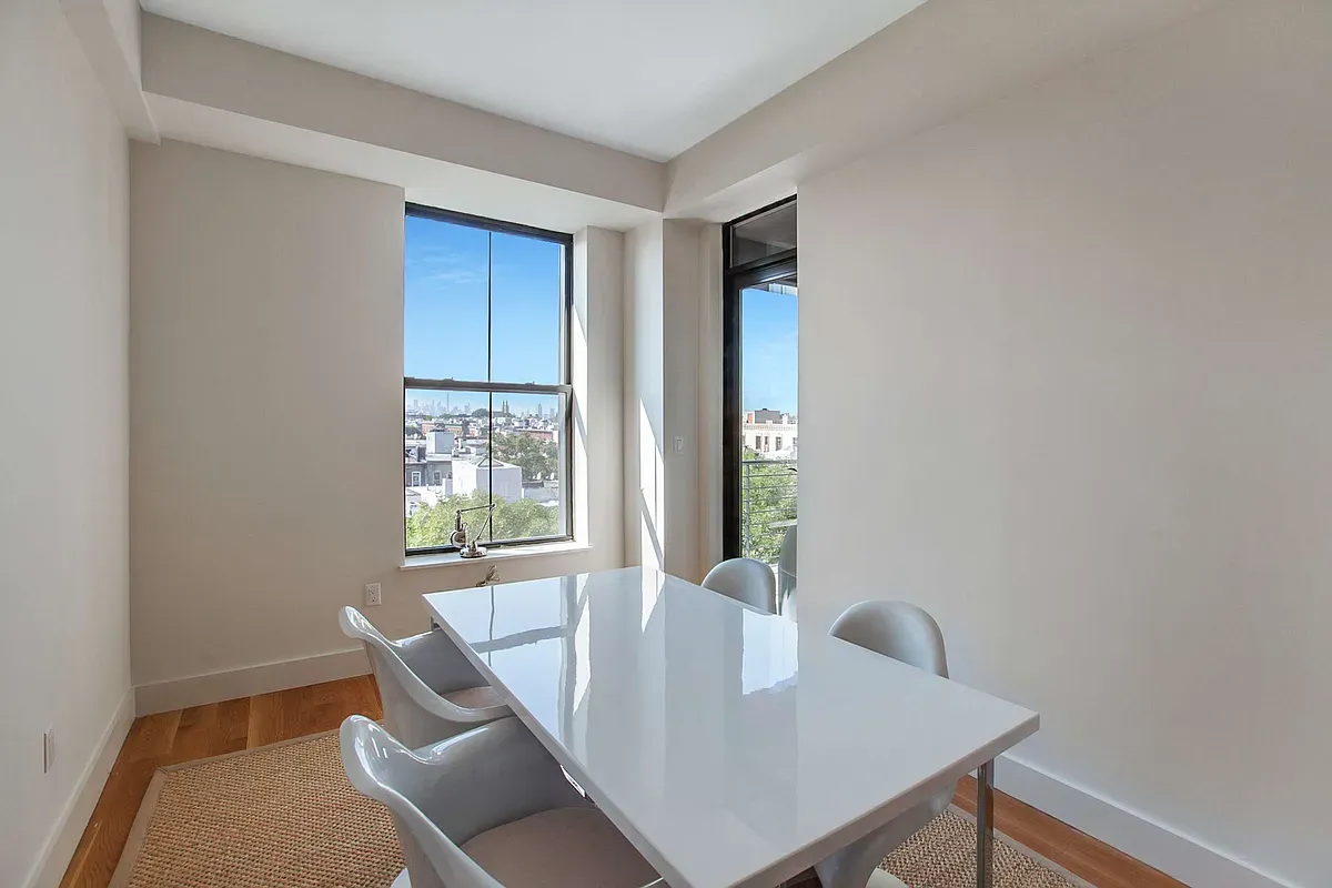 a view of a dining room with furniture and window