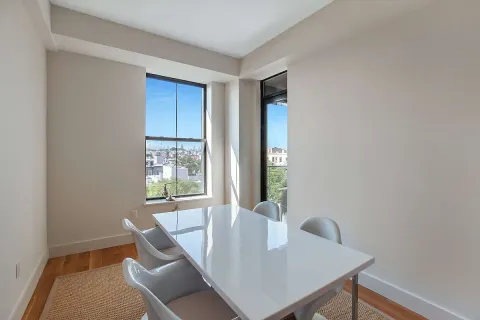 a view of a dining room with furniture and window